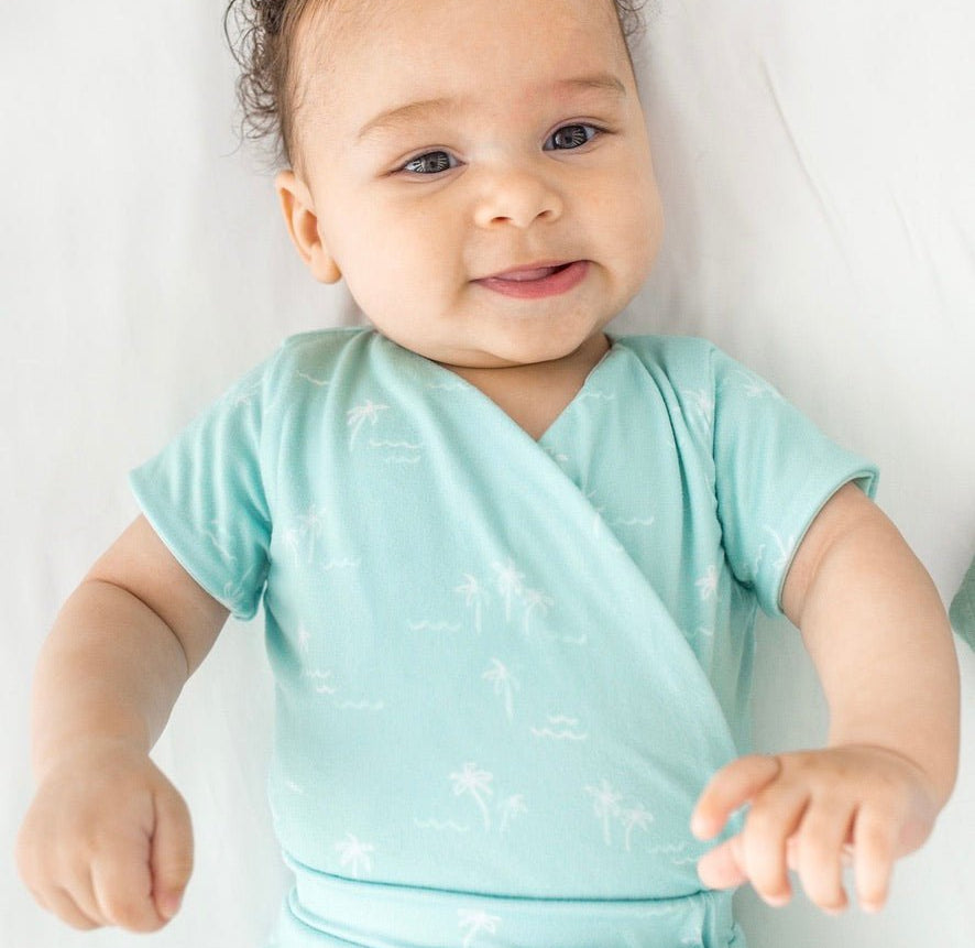 Short-sleeve winged bodysuit featuring the Honeydew Palms print in cozy classic brushed fabric.