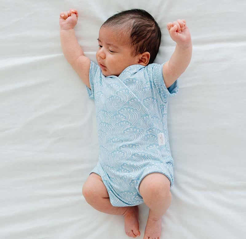 Everyday short-sleeve winged bodysuit with Blue Swells print and classic brushed softness.