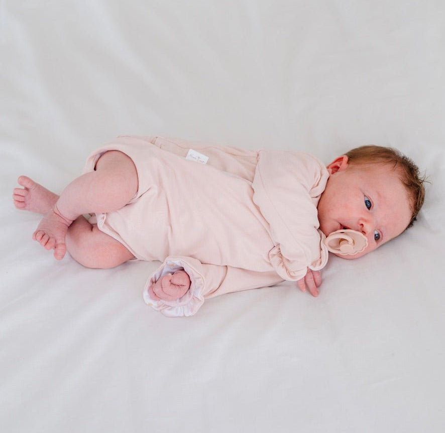 Comfortable Sweet Lily design brushed fabric reversible baby bodysuit with wings and ruffle trim cuffs.