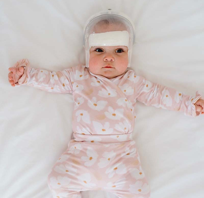 Classic brushed fabric baby bodysuit in Sweet Lily design with long sleeves, winged, and ruffle cuffs.