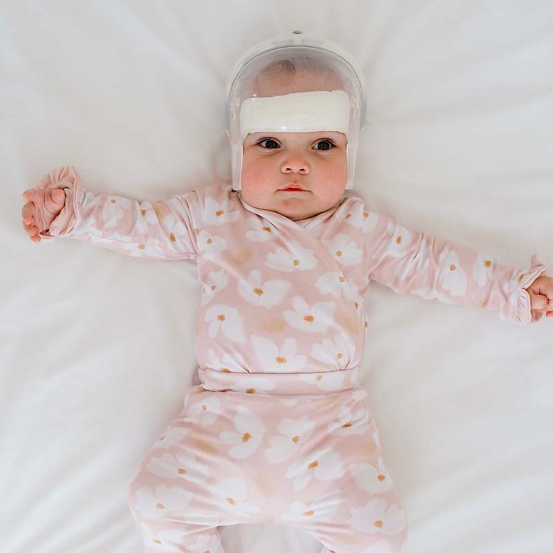 Classic brushed fabric baby bodysuit in Sweet Lily design with long sleeves, winged, and ruffle cuffs.