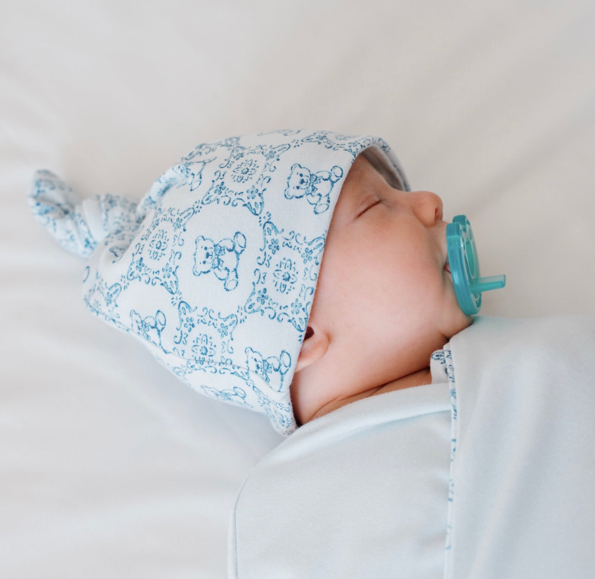 Reversible bamboo cotton baby knotty beanie in teddy tiles design.