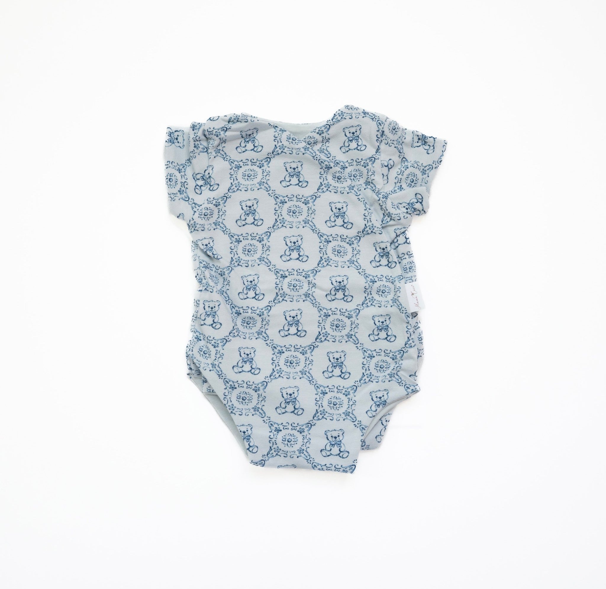 Reversible short-sleeve baby onesie in teddy tiles design.