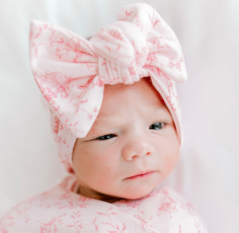 Sweet bow headwrap for babies made from soft bamboo and organic cotton fabric in a whimsical garden print.