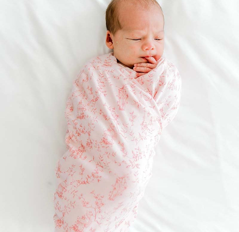 Organic cotton and bamboo baby swaddle cocoon blanket featuring a charming Whimsical Garden design.