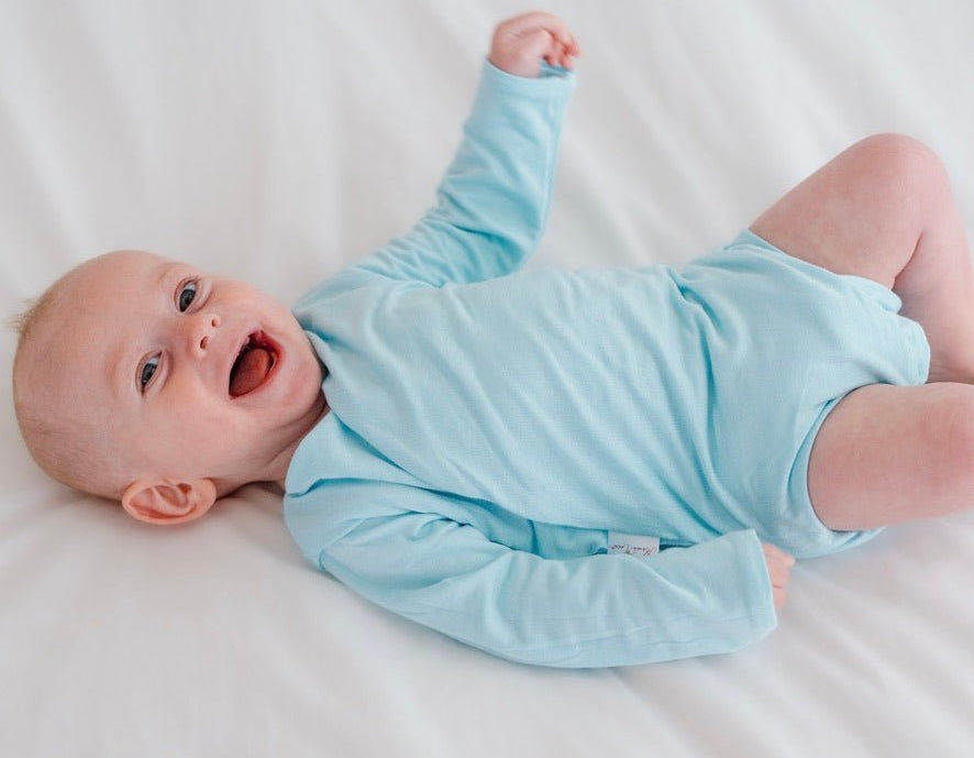 Long sleeved reversible winged bodysuit for babies in silky modal fabric.
