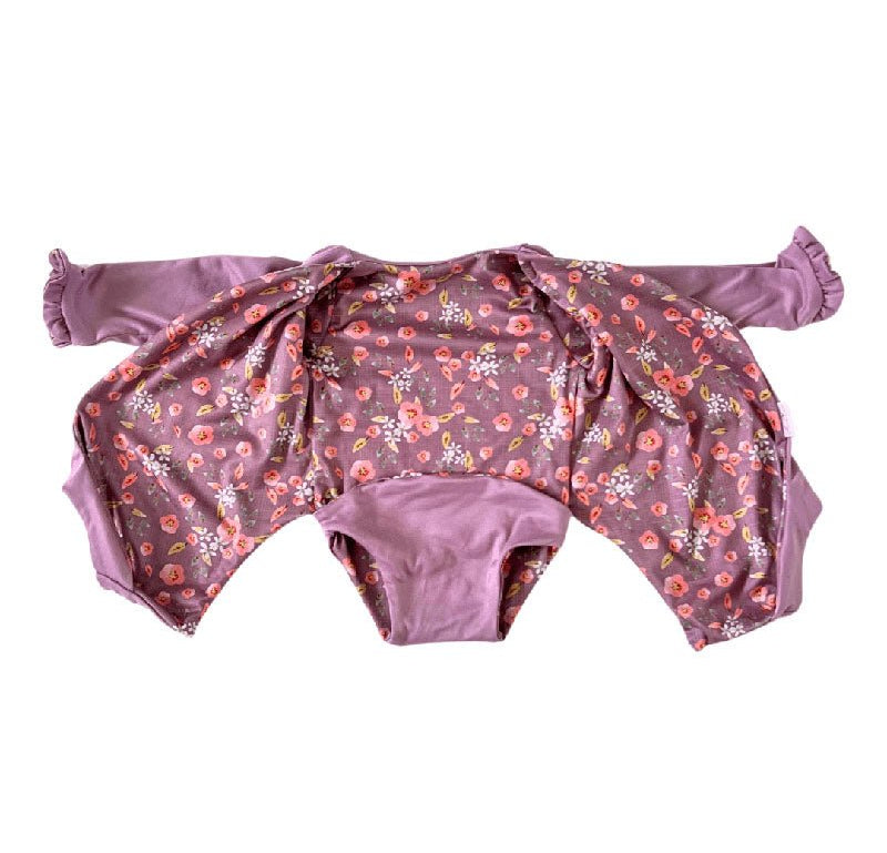 Comfortable Peachy Lilac design brushed fabric baby bodysuit with wings and ruffle trim cuffs.