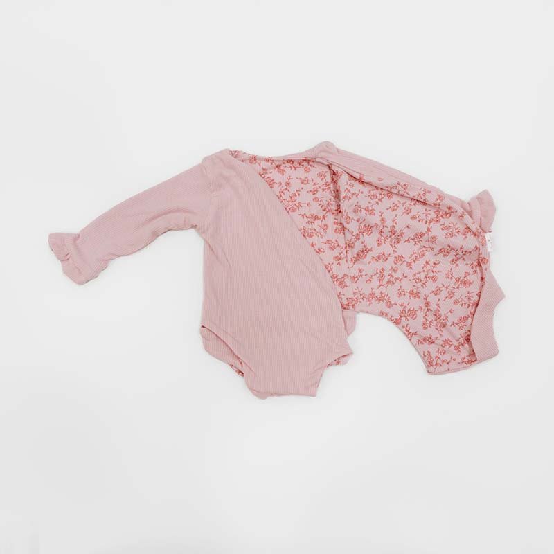 Reversible Bitty Pink Blooms design ruffle cuff long sleeved winged bodysuit in silky modal fabric.