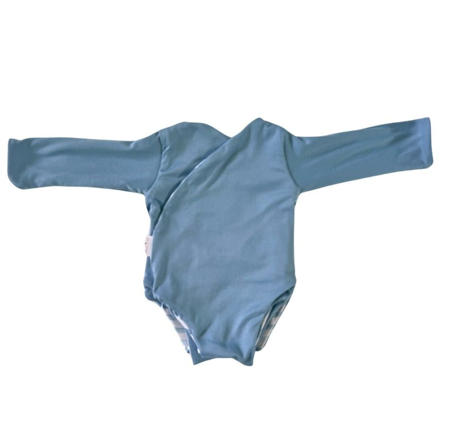 Long sleeved reversible winged bodysuit for babies in classic brushed fabric.