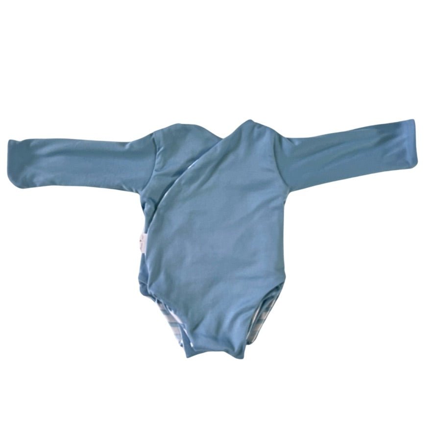Long sleeved reversible winged bodysuit for babies in classic brushed fabric.