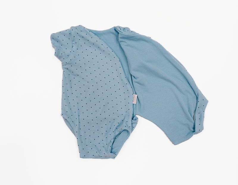 Reversible Dotted Blues design short sleeved winged bodysuit in silky modal fabric.