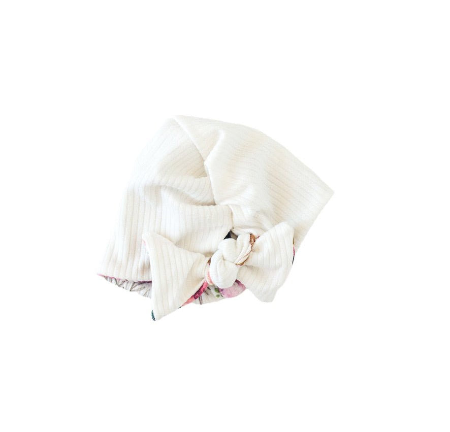 Reversible ruched beanie with bow for babies in Ivory Wildflowers with a soft fit.