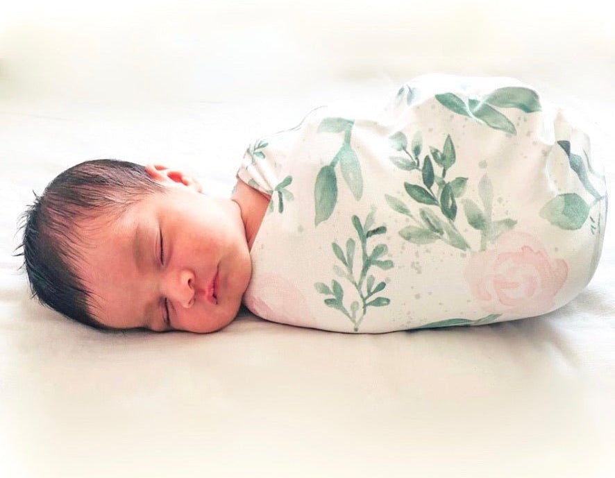 Baby cocoon swaddle featuring our blushing eucalyptus design, made from classic brushed fabric.