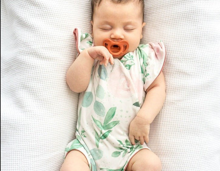 Blushing eucalyptus design flutter sleeve baby onesie and knotty beanie in classic brushed fabric.