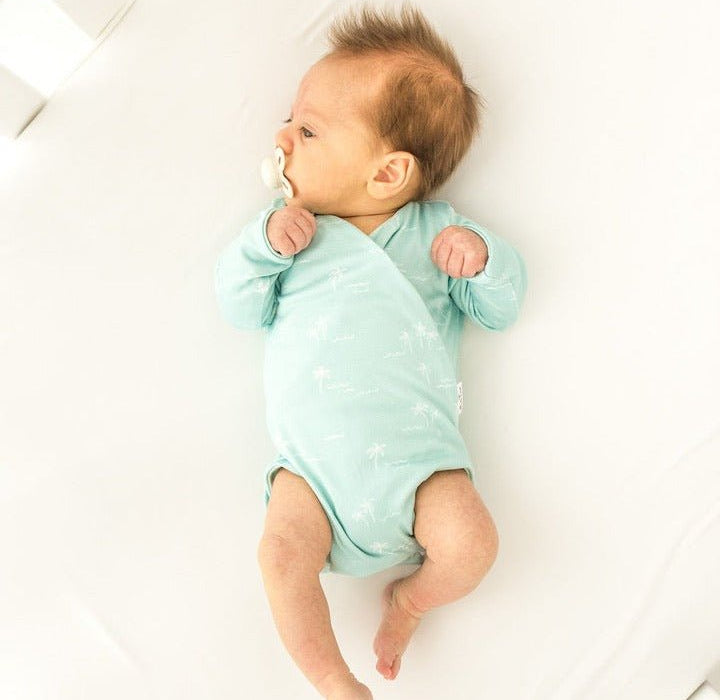 Honeydew Palms design long sleeve winged bodysuit.