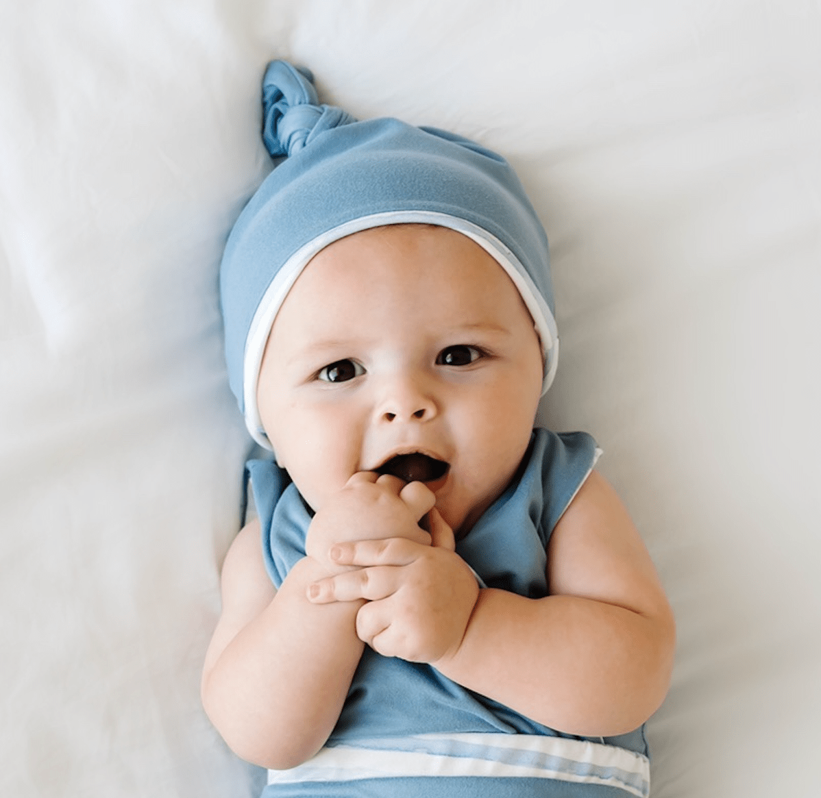 Reversible onesie outfit in chambray waves design includes beanie and winged bodysuit.