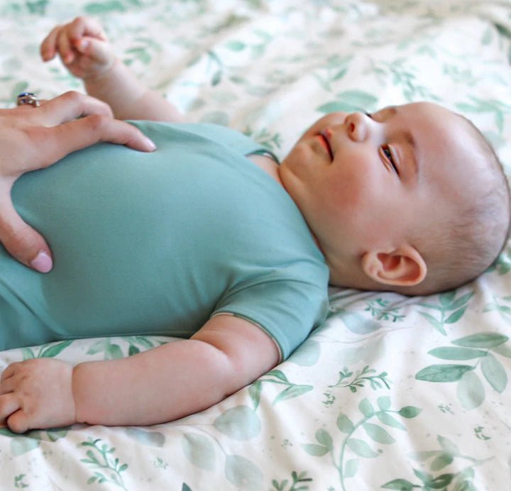 Reversible winged bodysuit in saged eucalyptus design.