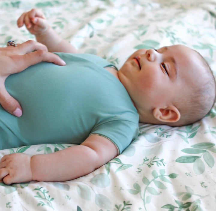 Reversible winged bodysuit in saged eucalyptus design.