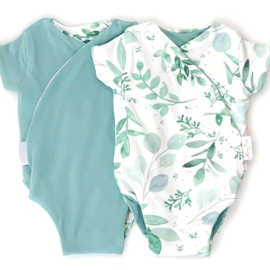 Reversible winged bodysuit in saged eucalyptus design.