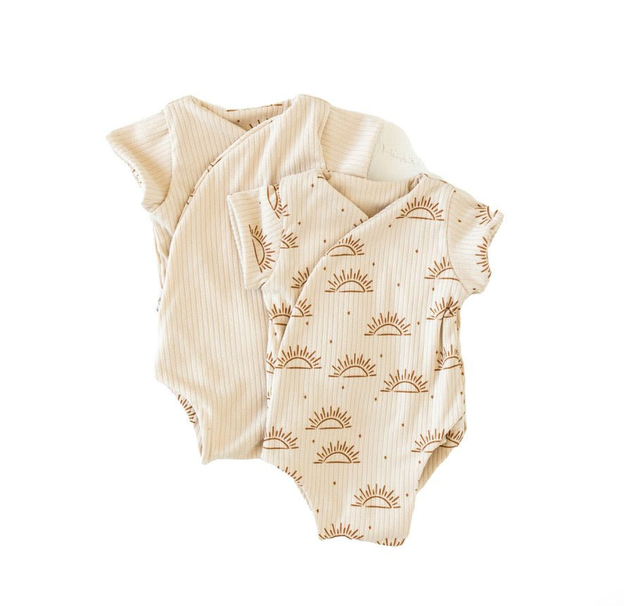 Reversible short-sleeve winged bodysuit in a sandy sunsets design.