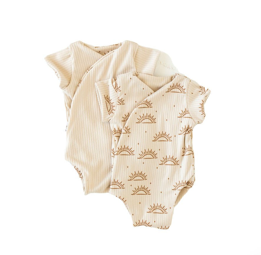 Reversible short-sleeve winged bodysuit in a sandy sunsets design.
