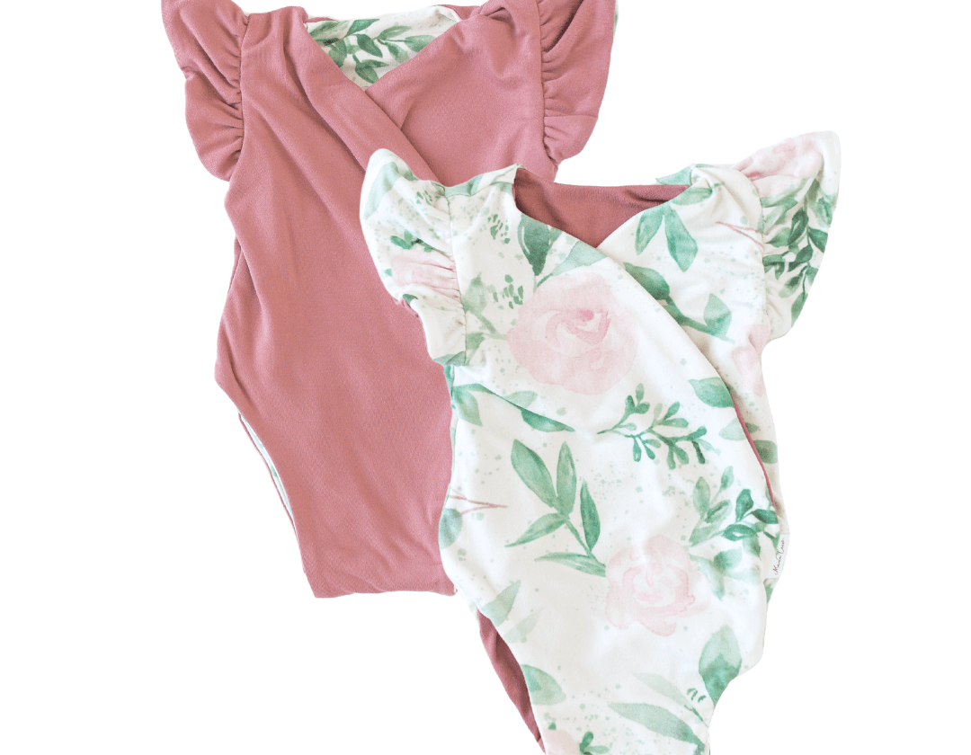 Reversible blushing eucalyptus design flutter sleeve baby onesie in classic brushed fabric.
