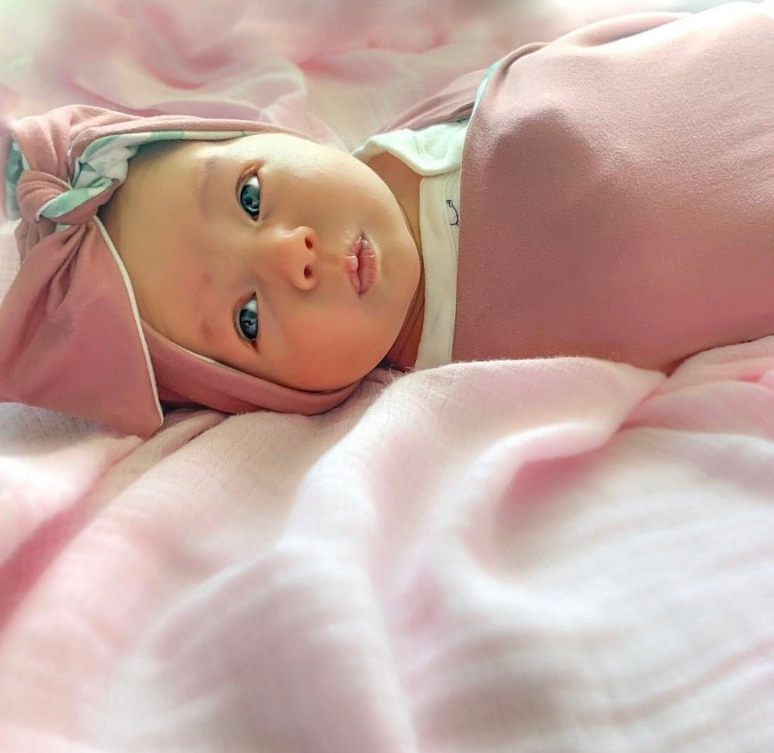 Adorable reversible ruched beanie with bow for babies in Blushing Eucalyptus with a soft stretchy fit.