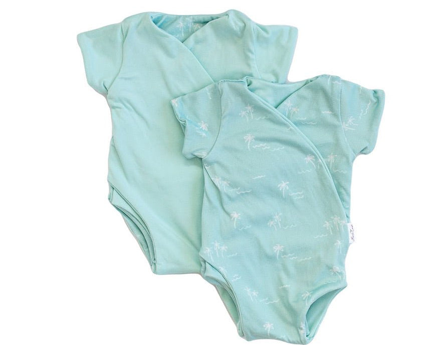 Reversible honeydew palms design short-sleeve baby onesie in classic brushed fabric.