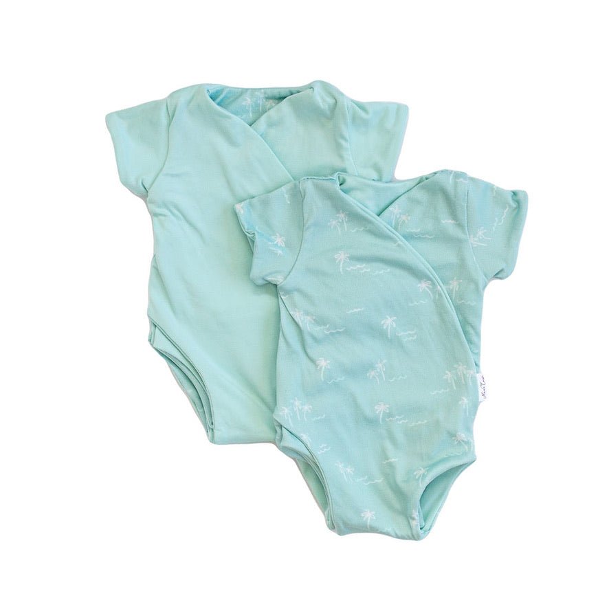 Reversible honeydew palms design short-sleeve baby onesie in classic brushed fabric.