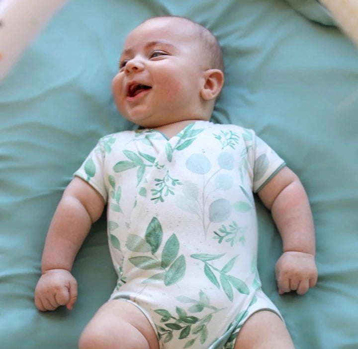 Reversible winged bodysuit in saged eucalyptus design.