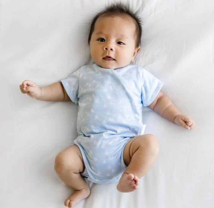Short-sleeve winged bodysuit in sailboat shores design.