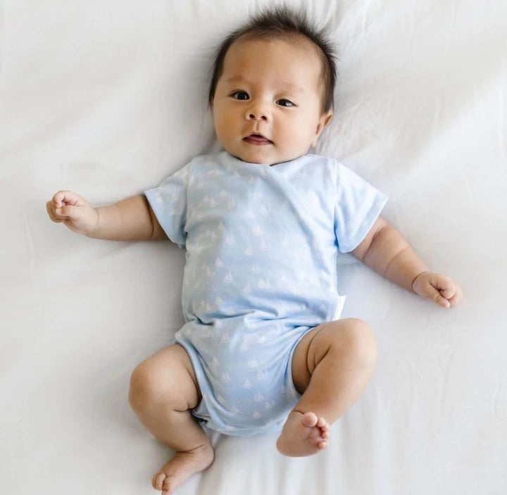 Short-sleeve winged bodysuit in sailboat shores design.
