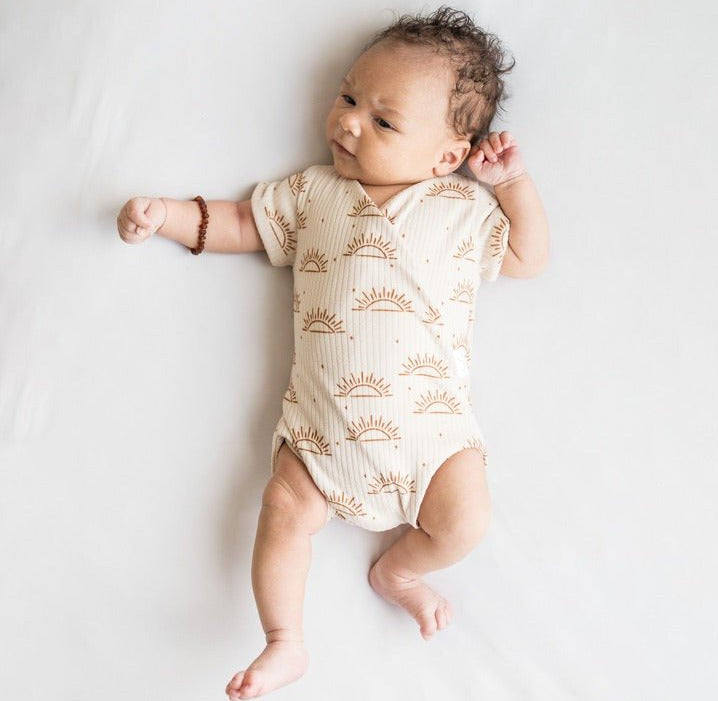 Reversible short-sleeve winged bodysuit in sandy sunsets design.
