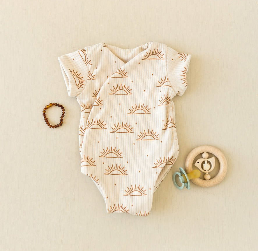 Soft classic brushed short-sleeve winged bodysuit in the Sandy Sunsets design for comfortable everyday wear.