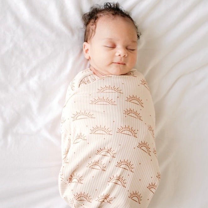 Soft baby cocoon swaddle made from Silky Modal in the Sandy Sunsets design.