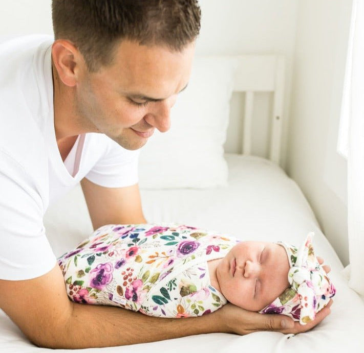 Soft baby cocoon swaddle made from Silky Modal in the Ivory Wildflowers design.