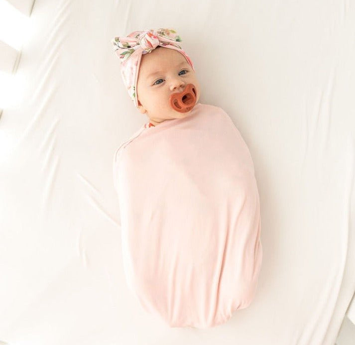Soft baby cocoon swaddle made from Silky Modal in the Peachy Rose Fields design.