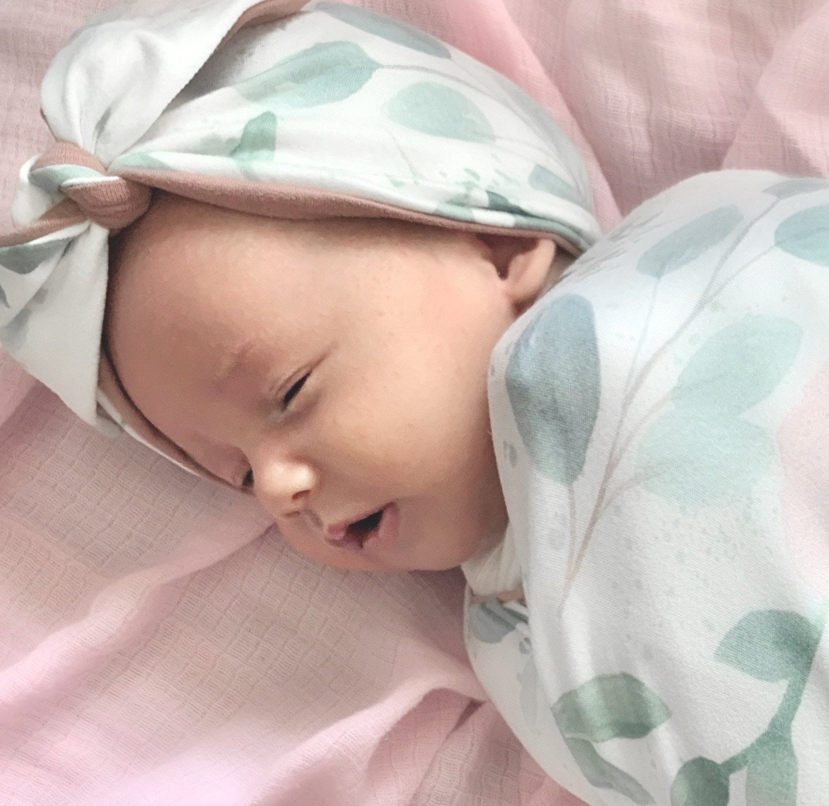 Cozy ruched beanie with bow for babies featuring the gentle Blushing Eucalyptus print.
