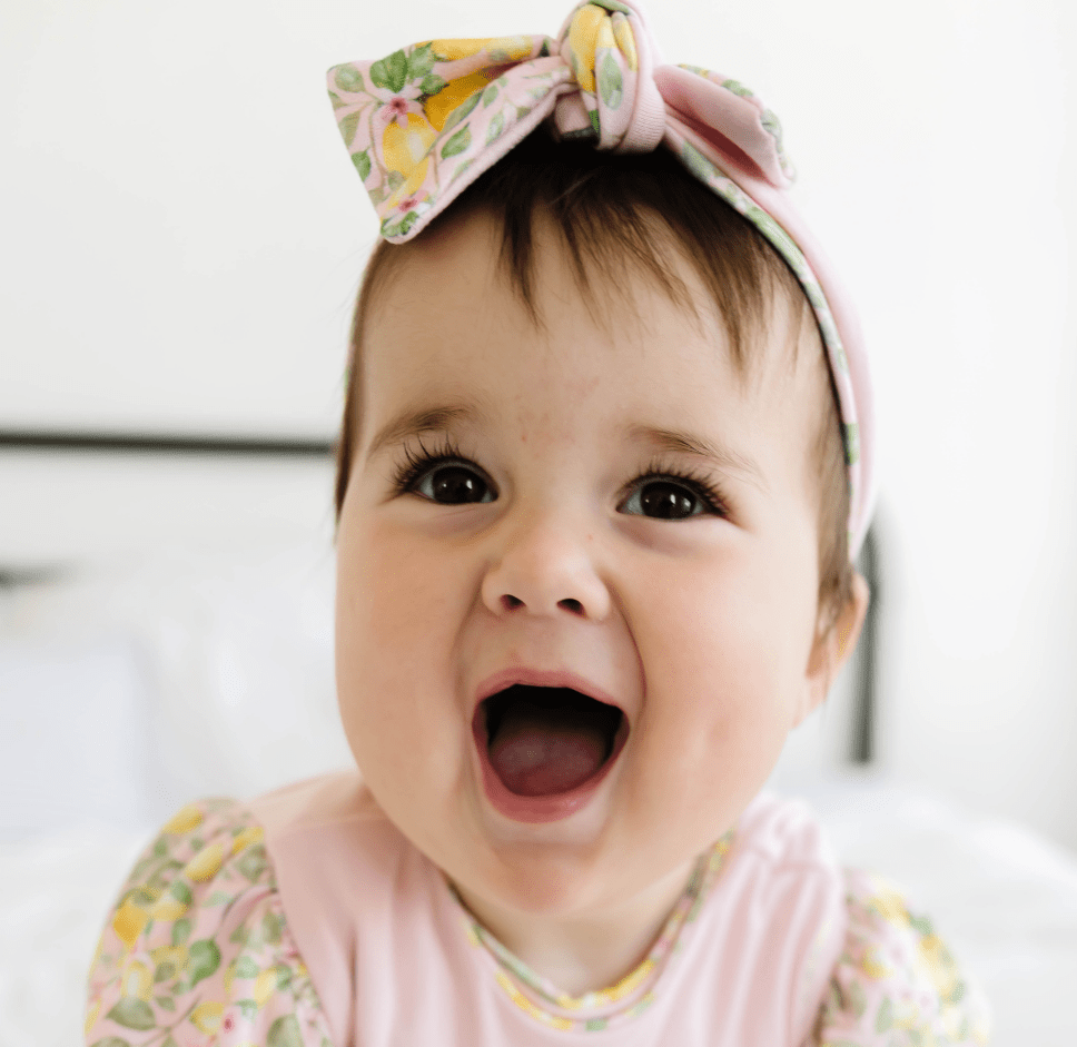 Cozy ruched beanie with bow for babies featuring the gentle Pink Lemonade print.