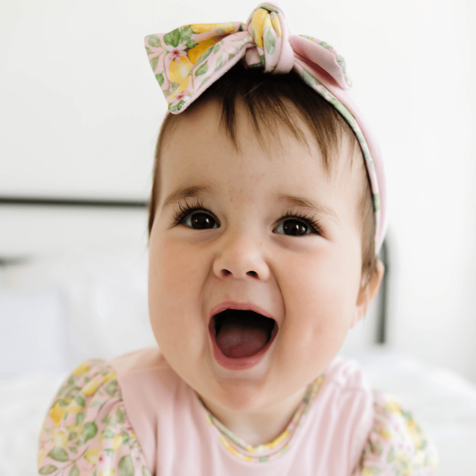 Cozy ruched beanie with bow for babies featuring the gentle Pink Lemonade print.