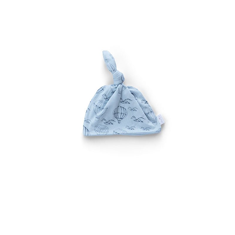 Reversible baby knotty beanie in bon voyage design.