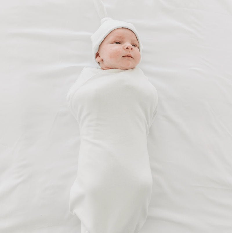 Timeless Baby Blue Gingham print on a Cocoon swaddle newborn blanket in Silky Modal fabric styles.