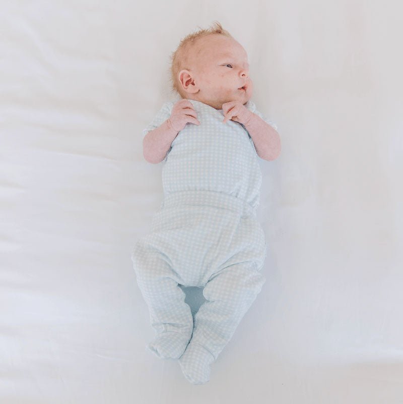 Baby footie pants crafted from soft silky modal fabric featuring the Baby Blue Gingham design.