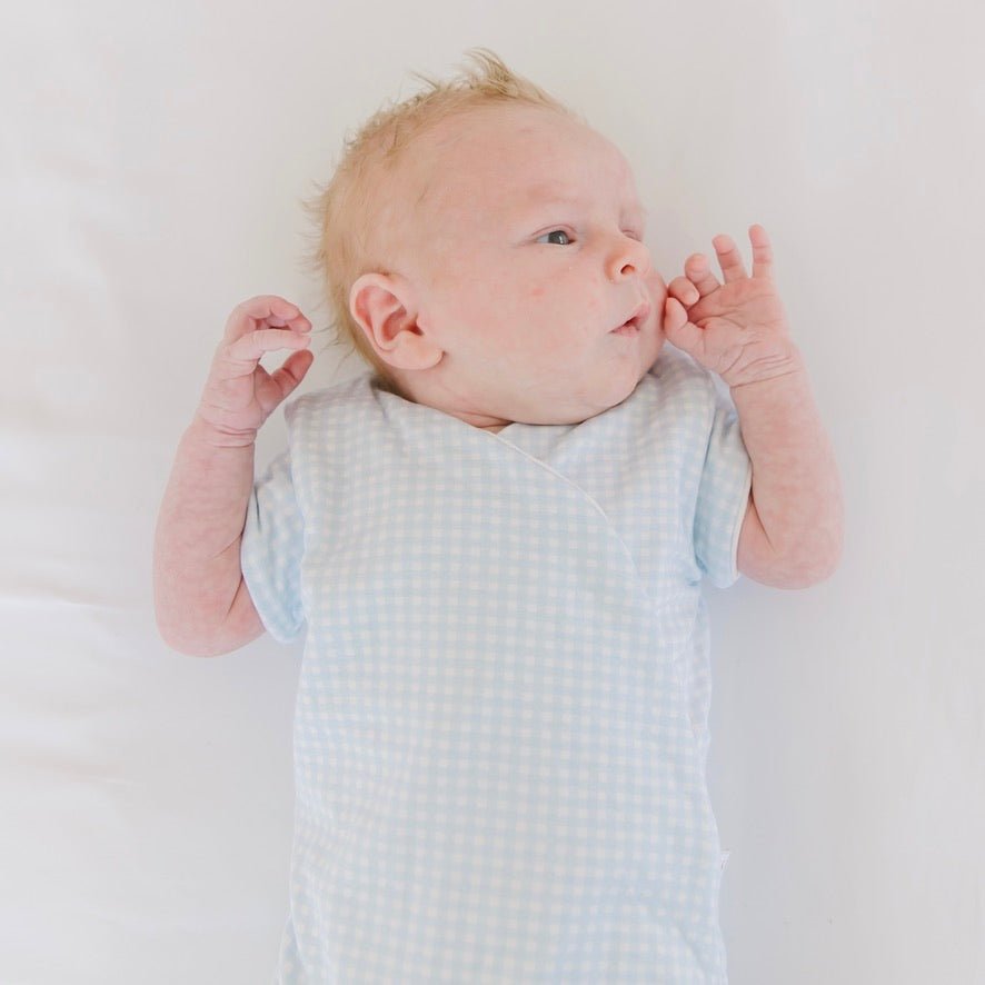 Baby blue gingham design short-sleeve baby onesie in silky modal fabric.