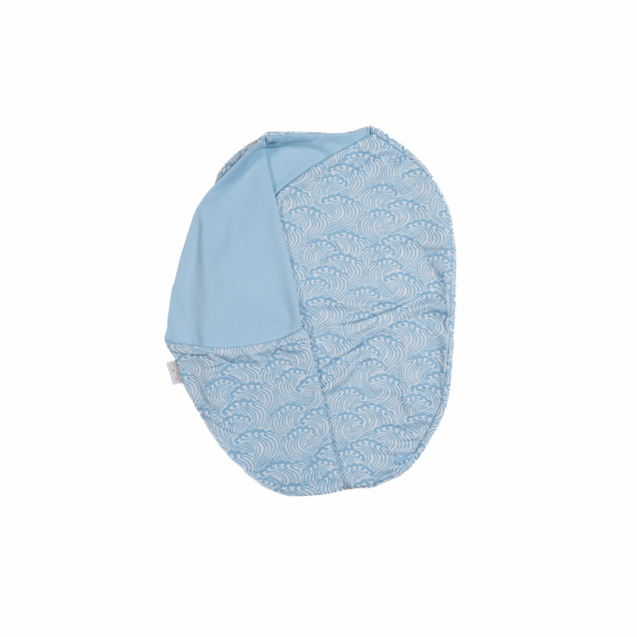 Baby cocoon swaddle featuring our blue swells design, made from classic brushed fabric.
