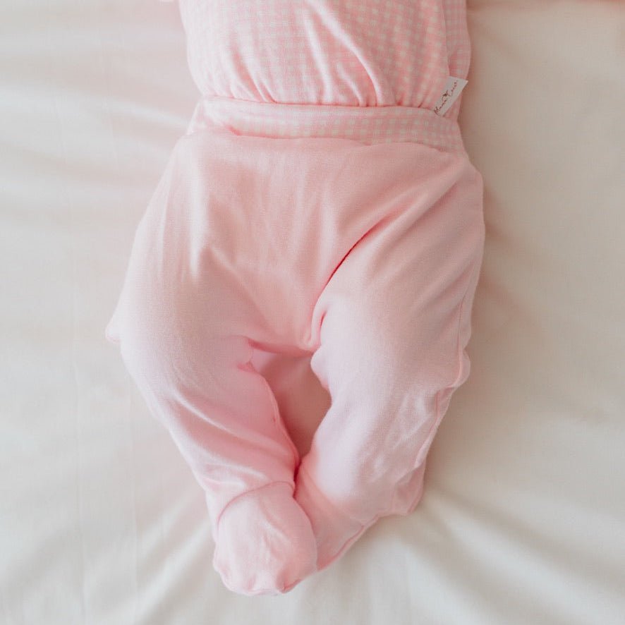Reversible baby footie pants in pink gingham design.