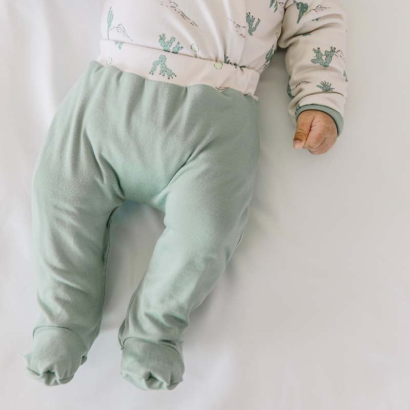 Soft and gentle baby footie pants made from bamboo cotton fabric in the Desert Sunsets design.