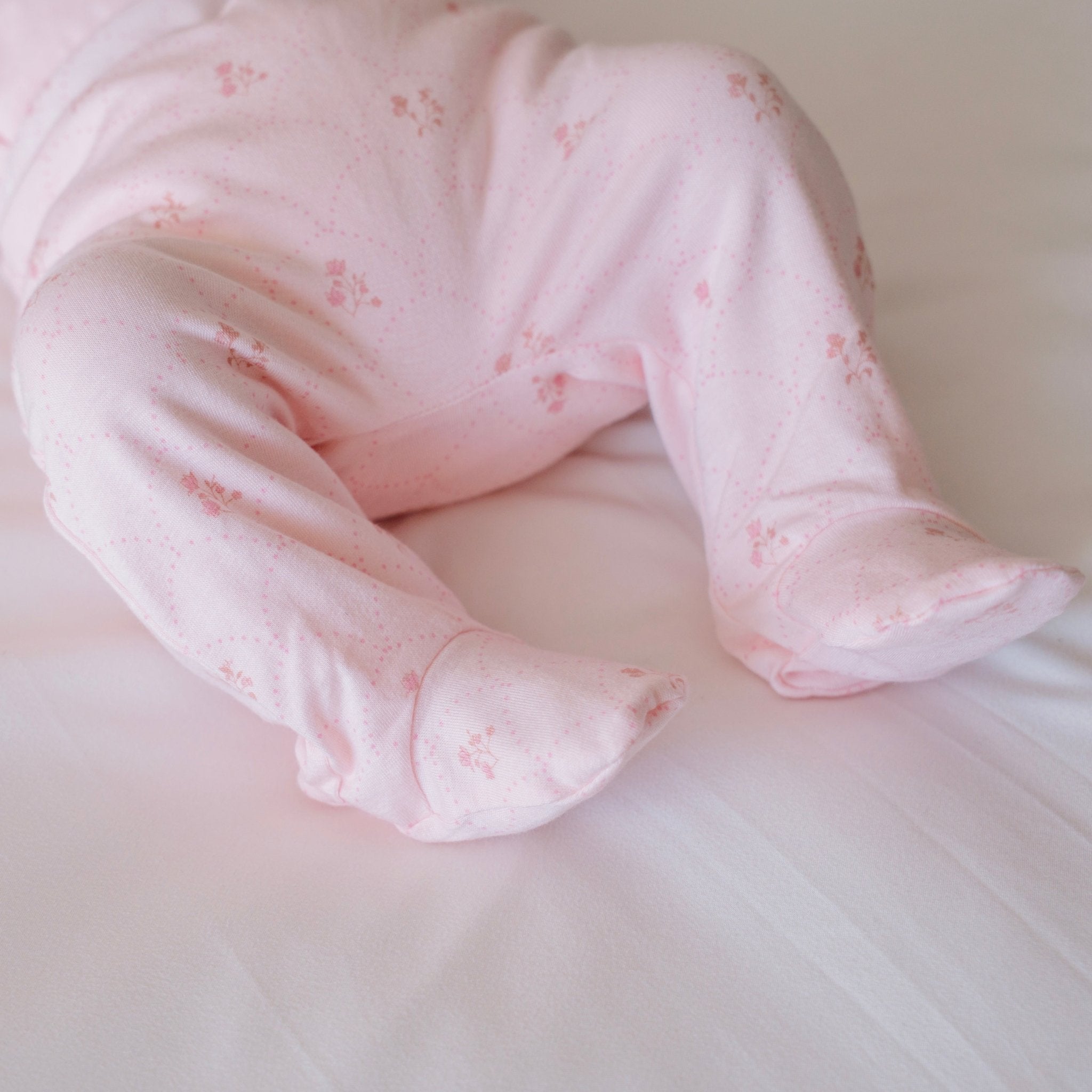 Baby footie pants in dainty dots design.