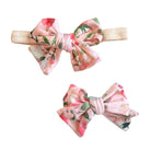 Soft baby bow headband and bow clip featuring the Peachy Rose Fields floral print.
