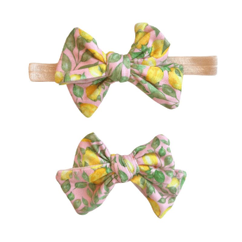 Soft baby bow headband and bow clip featuring the Pink Lemonade floral print.